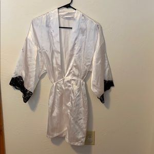 White robe with black lace detail. Size medium